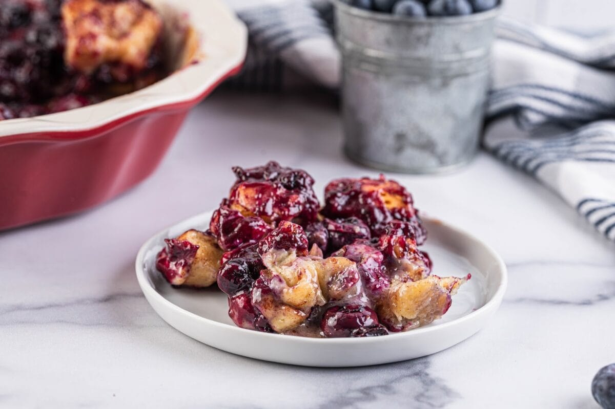 Blueberry cinnamon roll casserole with blueberry icing