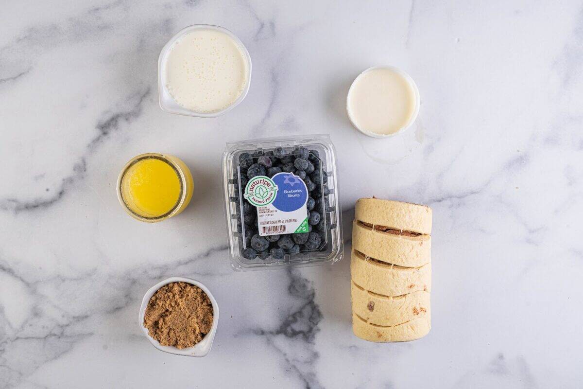 Blueberries, premade cinnamon roll dough, cinnamon, butter, cream, and icing