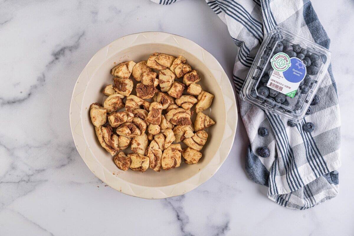 Cut the cinnamon roll dough into smaller pieces.