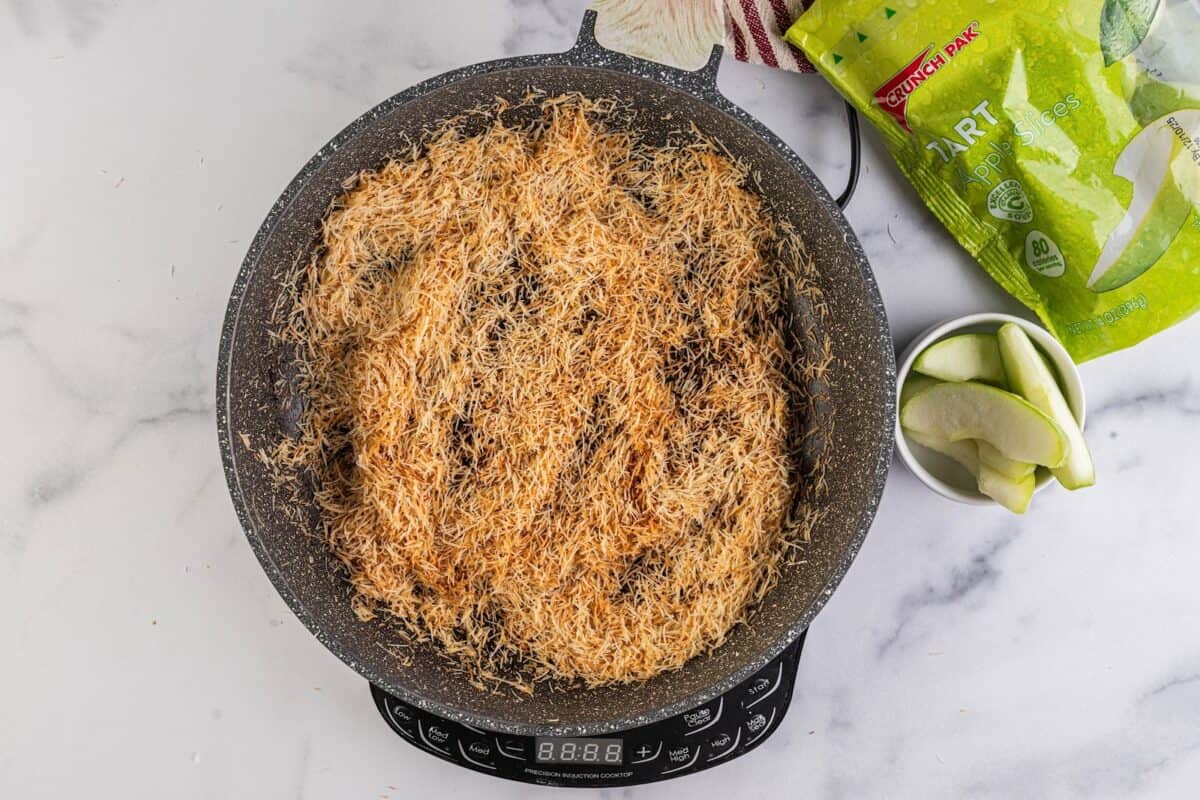 Kataifi cooking in a pot.