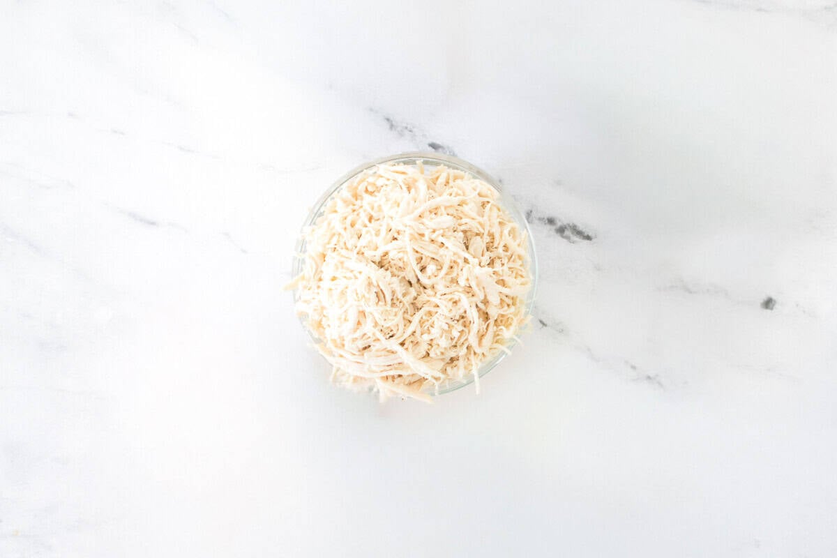 glass bowl of shredded chicken