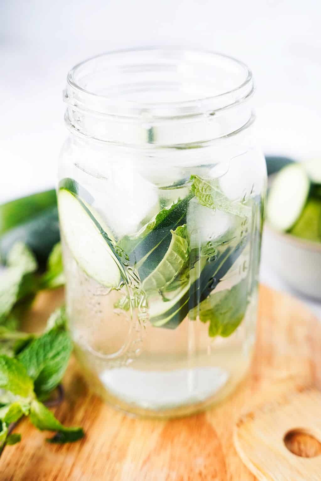 side view of cucumber water in a mason jar