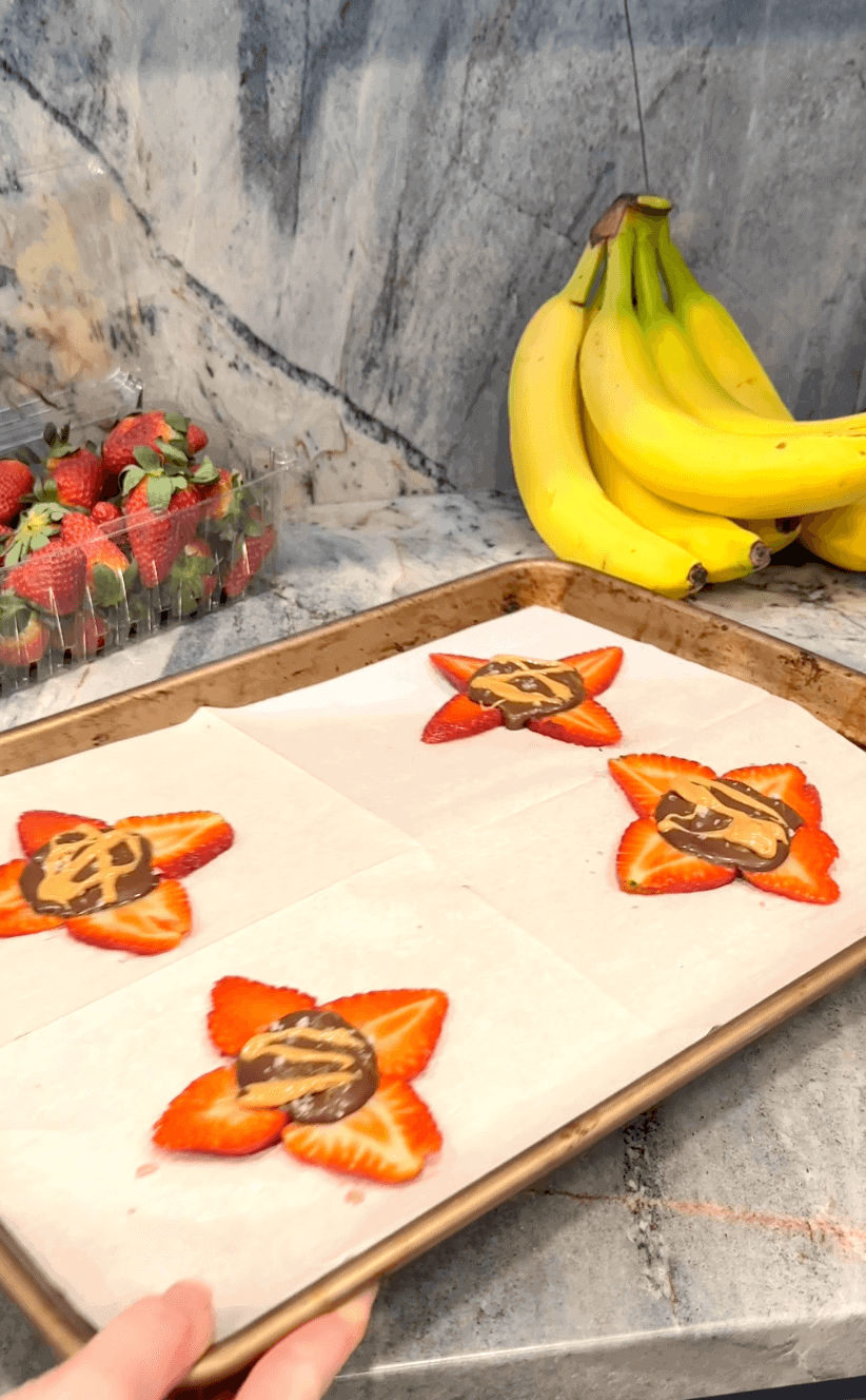 4 Strawberry Banana Bark Bites on parchmant-lined baking sheet before going into the freezer