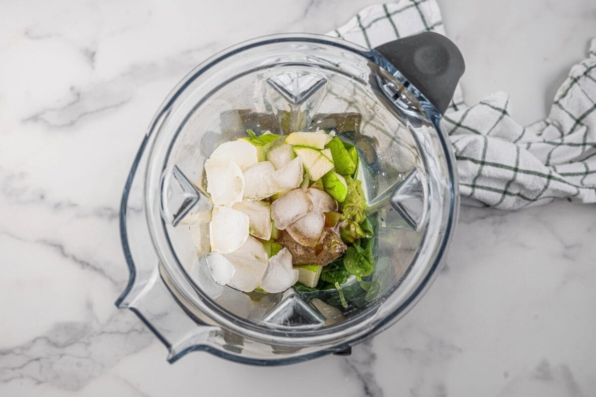 Green smoothie ingredients in a blender.