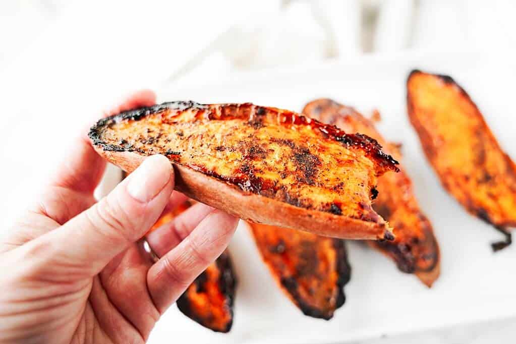 Close up with bite taken out of baked sweet potato half