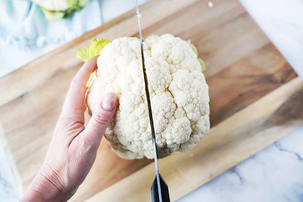 cutting cauliflower head in half