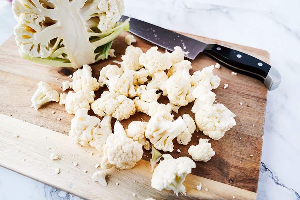 cauliflower florets on cuttign board