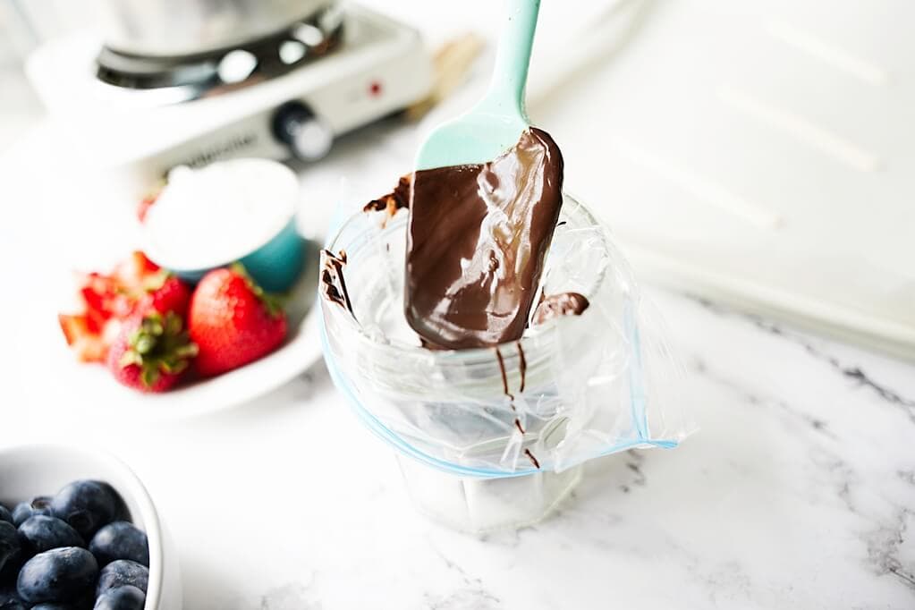 Spooning the melted chocolate into a piping bag