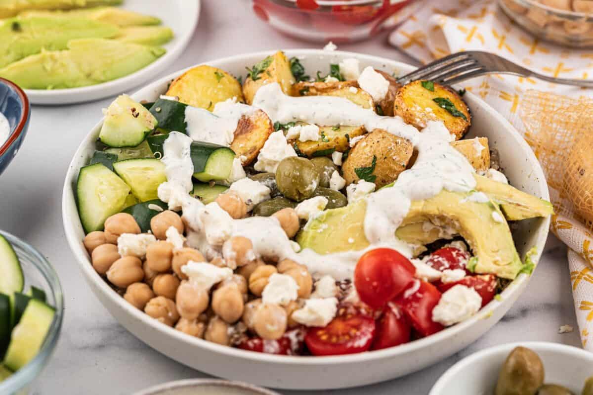 Mediterranean bowl with Tzatziki drizzle served on a table