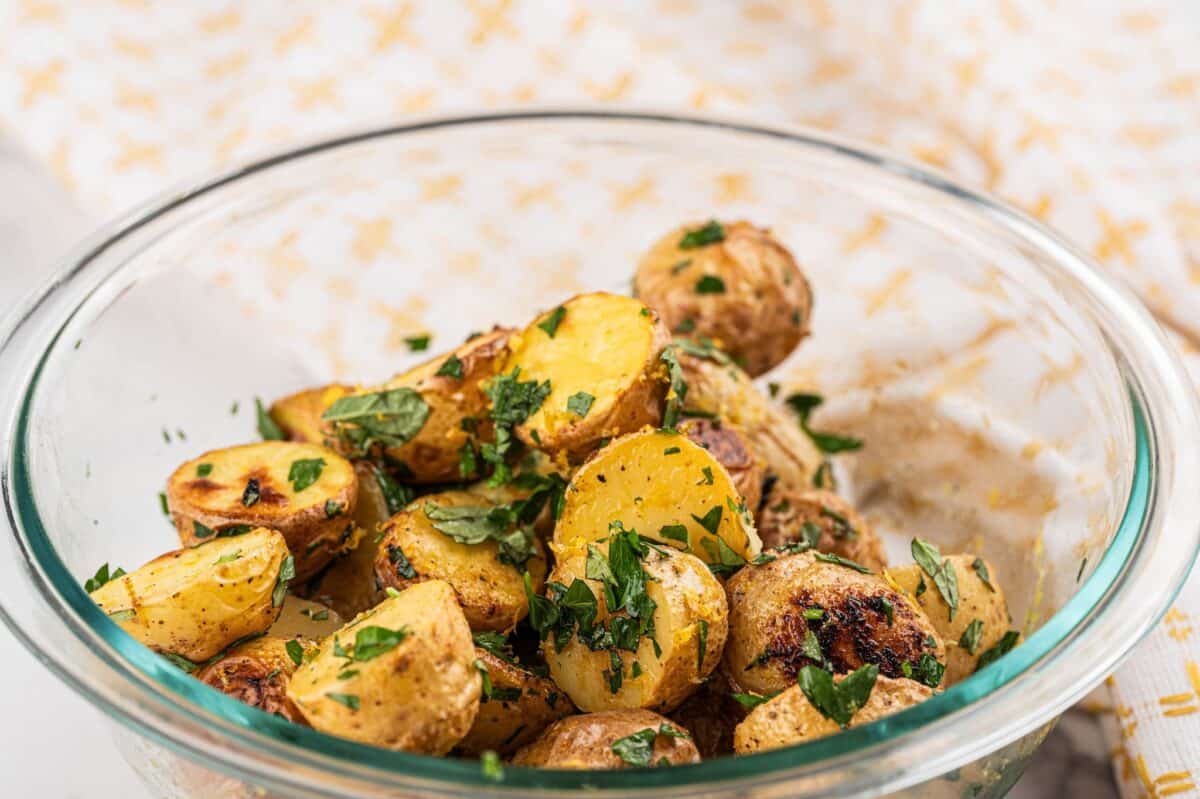 Crispy Greek potatoes in a bowl with herbs