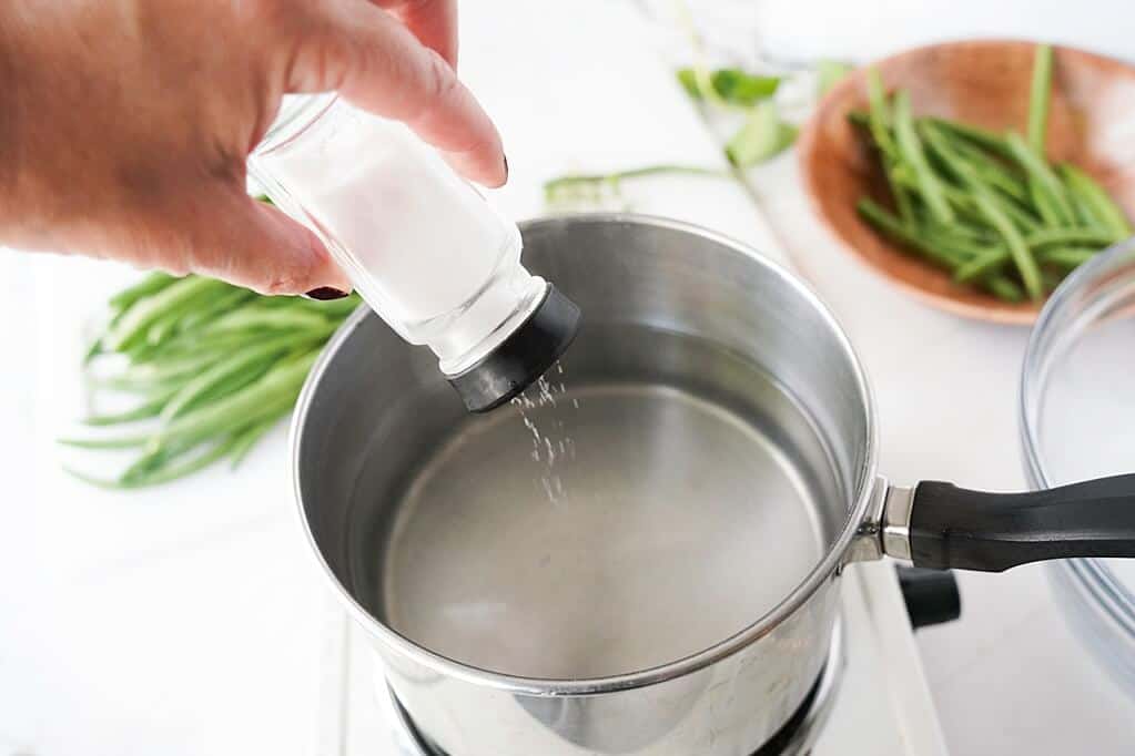 Adding salt to pot of water