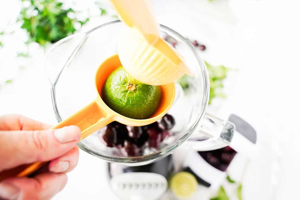 Lime in a juicer over the blender