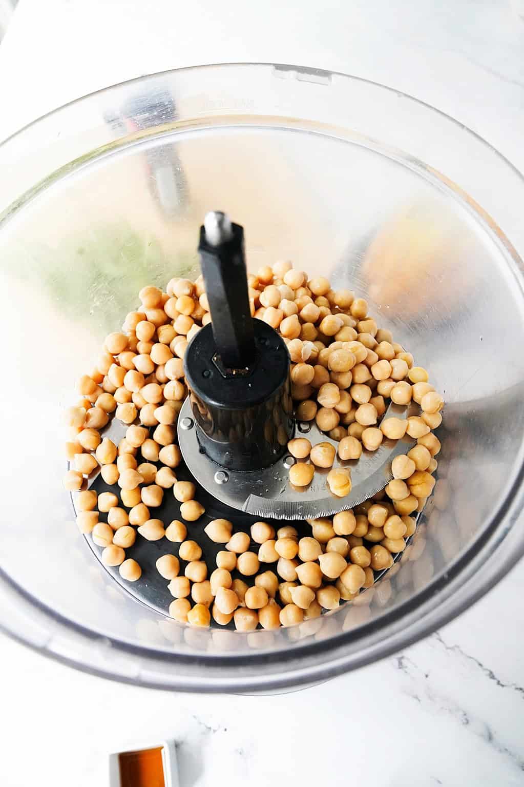 Drained and rinsed chickpeas in a food processor