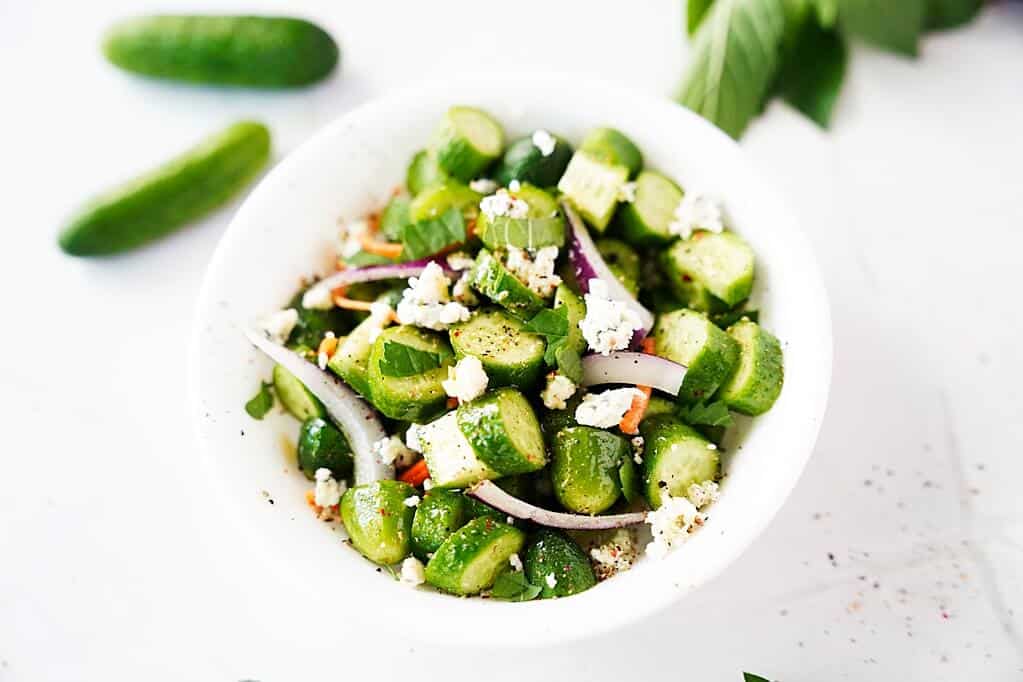 Cucumber salad in white bowl