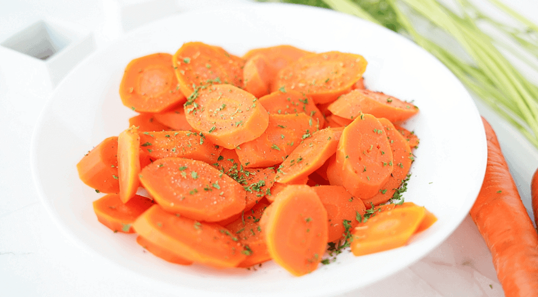Plated boiled carrots with seasoning