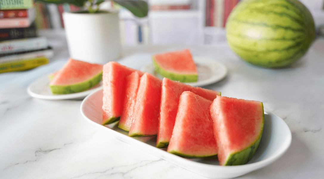Slices of watermelon on white plate on countertop