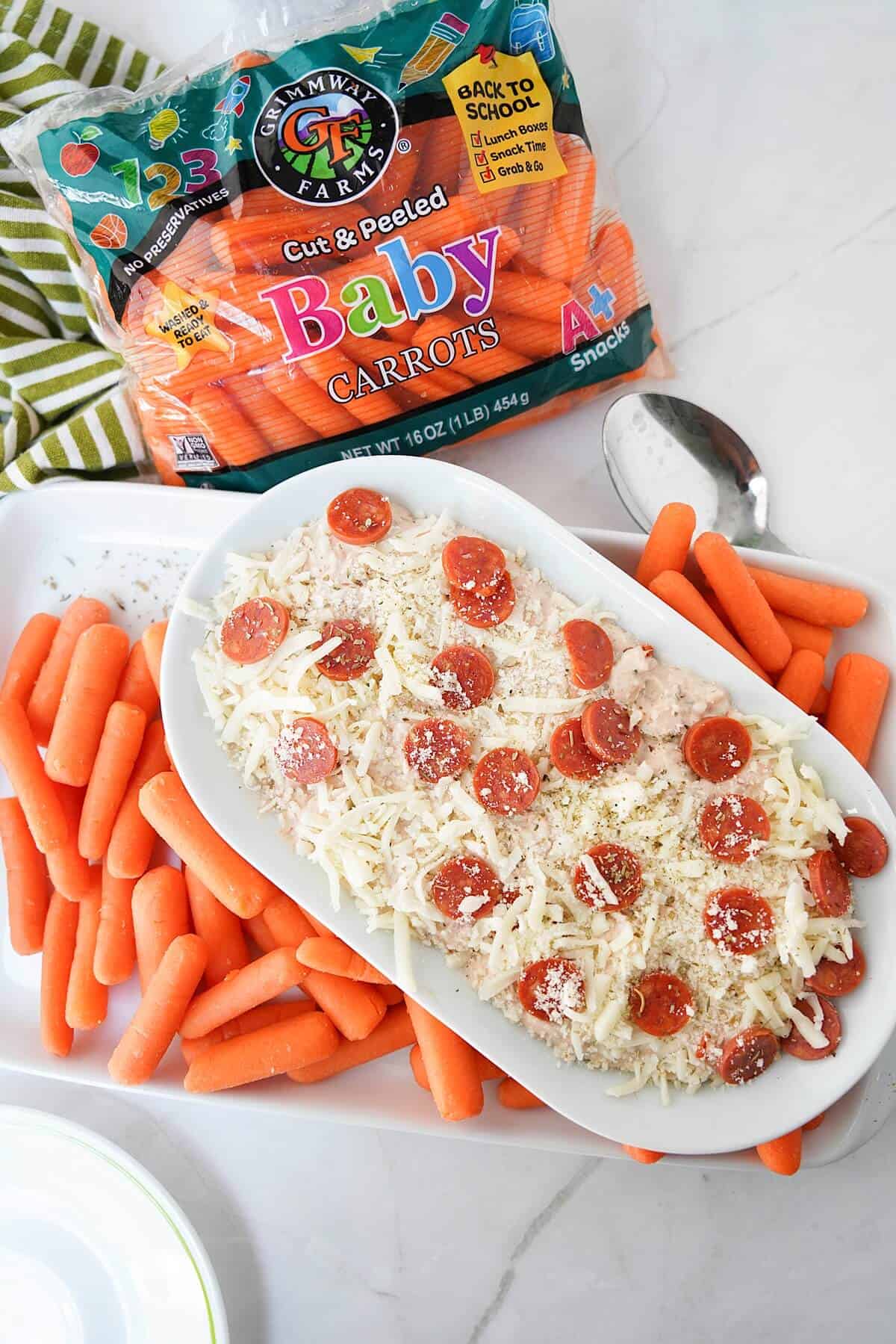 Ranch Pizza Dip on platter with baby carrots