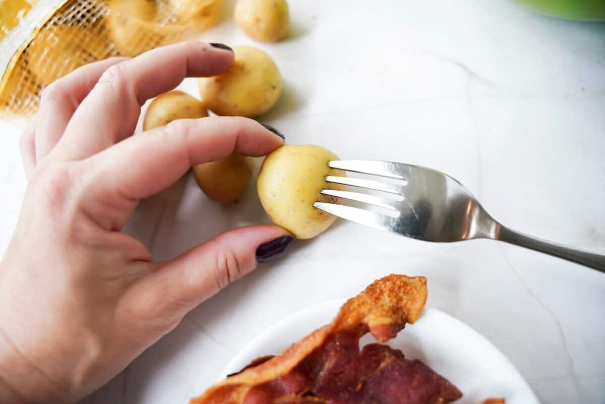 A small potato poked with a fork.