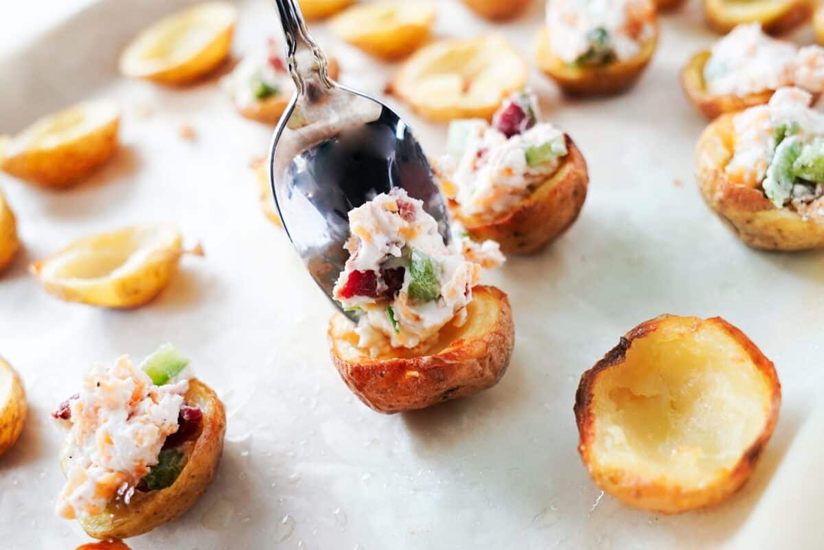 Use a tablespoon to fill the potato skins.