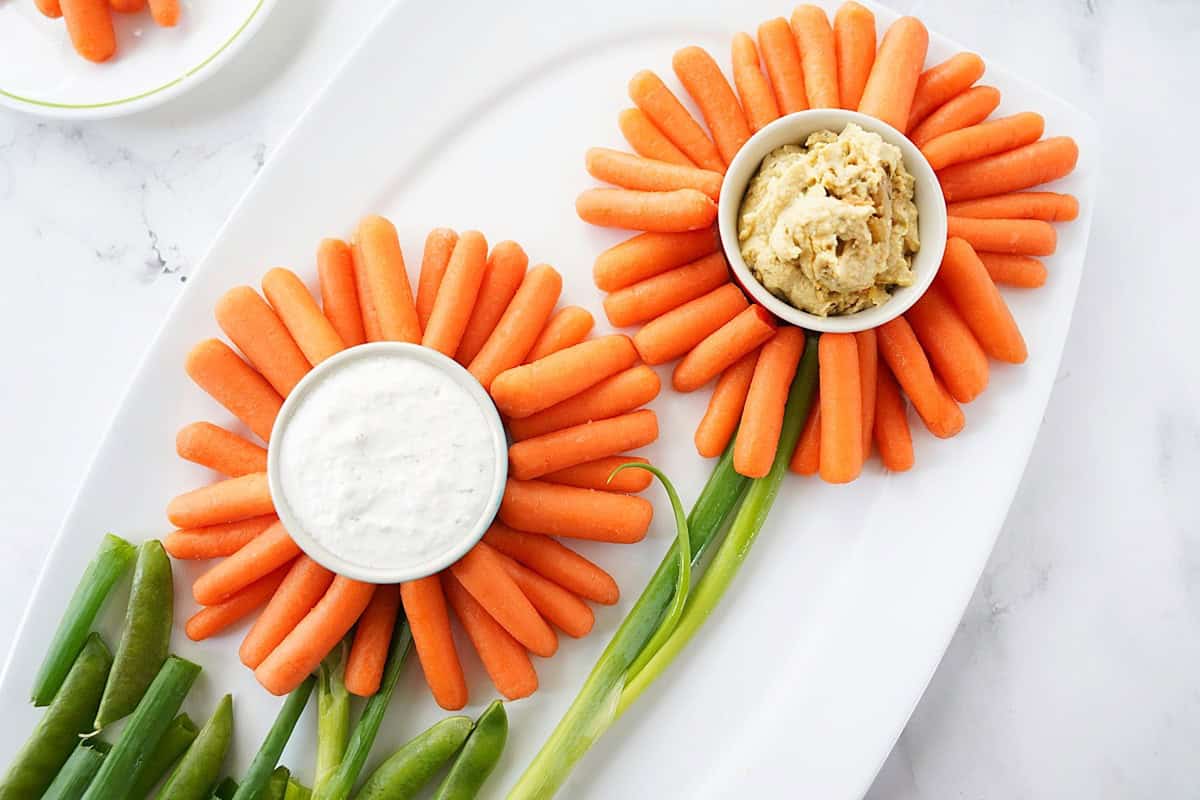 Baby carrots served with dip in the shape of flowers